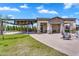 Expansive backyard featuring a covered patio, a built-in fire pit and green grass at 4037 E Minton Cir, Mesa, AZ 85215