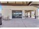 View of the backyard patio with retractable garage door and seating area at 4037 E Minton Cir, Mesa, AZ 85215