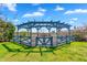 Landscaped backyard featuring a covered pergola and garden area with a fenced enclosure at 4037 E Minton Cir, Mesa, AZ 85215