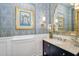 Elegant powder room featuring designer fixtures, patterned wallpaper, and classic wainscoting at 4037 E Minton Cir, Mesa, AZ 85215