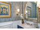 Powder bathroom with designer wallpaper, framed art, marble countertop, and gold fixtures at 4037 E Minton Cir, Mesa, AZ 85215