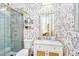 Stylish bathroom featuring glass shower, modern fixtures, and patterned wallpaper at 4037 E Minton Cir, Mesa, AZ 85215