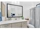 Bright bathroom featuring neutral vanity, large mirror, and stylish fixtures at 4037 E Minton Cir, Mesa, AZ 85215