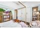 Bright bedroom with a four poster bed, large closet, and decoratively wallpapered ensuite bathroom at 4037 E Minton Cir, Mesa, AZ 85215