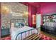 Bedroom with a decorative brick wall and exposed bulb chandelier, next to a painted pink wall at 4037 E Minton Cir, Mesa, AZ 85215