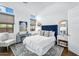 Comfortable bedroom with a blue headboard, large windows, and decorative rug at 4037 E Minton Cir, Mesa, AZ 85215