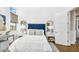 Bright bedroom with white walls, an upholstered headboard, and hardwood floors at 4037 E Minton Cir, Mesa, AZ 85215