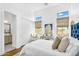 Bright bedroom boasts modern decor, natural light, and wood floors at 4037 E Minton Cir, Mesa, AZ 85215