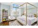 Cozy bedroom featuring natural light, wood floors, and stylish decor at 4037 E Minton Cir, Mesa, AZ 85215