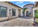 Private courtyard featuring paver flooring, exterior lighting, and a beautifully decorated wrought iron door at 4037 E Minton Cir, Mesa, AZ 85215