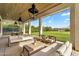 Spacious covered patio with an open view of the backyard and distant pergola covered seating area at 4037 E Minton Cir, Mesa, AZ 85215