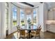 Charming dining nook with bay windows, natural light, designer lighting, and seating for six at 4037 E Minton Cir, Mesa, AZ 85215