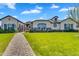 Stunning single Gathering home featuring beautiful landscaping, a paver walkway, and a private gated entrance at 4037 E Minton Cir, Mesa, AZ 85215
