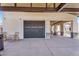 Spacious garage featuring a screen door, concrete flooring, and adjacent covered patio area at 4037 E Minton Cir, Mesa, AZ 85215