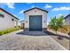 Detached garage with a paved driveway, landscaped yard, and charming architectural details at 4037 E Minton Cir, Mesa, AZ 85215