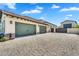 Exterior shot showcasing a three-car garage with paved driveway and well-maintained landscaping at 4037 E Minton Cir, Mesa, AZ 85215