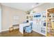 Bright home office featuring custom white cabinetry, built-in desk, and wood flooring at 4037 E Minton Cir, Mesa, AZ 85215