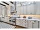 Spacious kitchen featuring stainless steel appliances, white custom cabinets, and hardwood floors at 4037 E Minton Cir, Mesa, AZ 85215