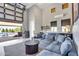 Stylish living room with a wet bar, comfortable seating, and an automated garage door to the pool and spa area at 4037 E Minton Cir, Mesa, AZ 85215