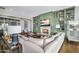 Open living room with fireplace, green custom cabinets, and comfortable seating area at 4037 E Minton Cir, Mesa, AZ 85215