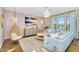 Stylish living room with pink accent wall, hanging chair, and large picture window at 4037 E Minton Cir, Mesa, AZ 85215