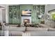 Inviting living room with a fireplace and custom green built-in shelving and cabinets at 4037 E Minton Cir, Mesa, AZ 85215