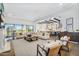 Spacious open concept living room leading to the kitchen area and a sliding glass door at 4037 E Minton Cir, Mesa, AZ 85215
