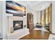 Inviting living room features a cozy fireplace, hardwood floors, and beautiful natural light at 4037 E Minton Cir, Mesa, AZ 85215