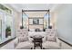 Spacious main bedroom with a four poster bed, tufted chairs, and serene decor at 4037 E Minton Cir, Mesa, AZ 85215