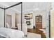 Comfortable main bedroom with a fireplace, hardwood floors, and a stylish display cabinet at 4037 E Minton Cir, Mesa, AZ 85215