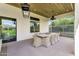 Spacious covered patio with an outdoor dining area, stylish decor and backyard access at 4037 E Minton Cir, Mesa, AZ 85215