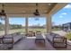 Covered patio with comfortable seating and open views of the expansive backyard at 4037 E Minton Cir, Mesa, AZ 85215