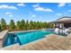 Luxurious pool and spa area with lush landscaping and covered patio at 4037 E Minton Cir, Mesa, AZ 85215