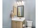 Charming powder room with a vanity, stylish mirror, and decorative light fixture at 4037 E Minton Cir, Mesa, AZ 85215