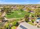 Overhead view featuring a community green space with soccer goals near residences with solar panels and private pools at 4638 S San Benito Ct, Gilbert, AZ 85297