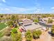 Expansive aerial view of a suburban home with solar panels, lush landscaping, and a glimpse of a pool at 4638 S San Benito Ct, Gilbert, AZ 85297