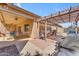 The covered back patio includes a dining table with chairs, a ceiling fan, and views of the pergola at 4638 S San Benito Ct, Gilbert, AZ 85297