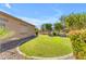 Serene backyard with lush lawn, decorative bushes, mature trees, and rock landscaping, offering privacy at 4638 S San Benito Ct, Gilbert, AZ 85297