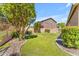 Well-maintained backyard with lush lawn, mature trees, and stone accents creating a peaceful outdoor retreat at 4638 S San Benito Ct, Gilbert, AZ 85297