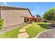 Expansive backyard features lush lawn, stone pathways, covered patio, grill, and serene landscaping at 4638 S San Benito Ct, Gilbert, AZ 85297
