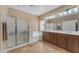 Bright bathroom with double vanity, glass shower, and tile floors at 4638 S San Benito Ct, Gilbert, AZ 85297
