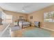 Inviting bedroom featuring two rugs, a ceiling fan and sunny windows at 4638 S San Benito Ct, Gilbert, AZ 85297