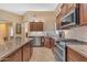 Modern kitchen features stainless steel appliances, granite counters, and beautiful wood cabinets at 4638 S San Benito Ct, Gilbert, AZ 85297