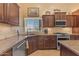 Well-equipped kitchen features stainless steel appliances, granite counters, and tile backsplash at 4638 S San Benito Ct, Gilbert, AZ 85297