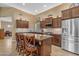 Eat-in kitchen featuring tile flooring, granite counters and an island with breakfast bar at 4638 S San Benito Ct, Gilbert, AZ 85297