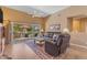 Cozy living room with a ceiling fan, tile floors, and access to the patio at 4638 S San Benito Ct, Gilbert, AZ 85297