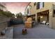 Spacious backyard with an outdoor kitchen, fire pit, and comfortable seating area, perfect for relaxing and entertaining at 470 N 168Th Ln, Goodyear, AZ 85338