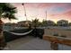 Outdoor kitchen area featuring a pizza oven and hammock, perfect for relaxation and entertaining at 470 N 168Th Ln, Goodyear, AZ 85338