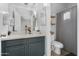 Bright bathroom featuring a modern vanity and coordinated gray and white shower curtain at 470 N 168Th Ln, Goodyear, AZ 85338