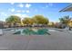 Bright community pool with a paved deck and lounge chairs, perfect for enjoying the sunshine and relaxation at 470 N 168Th Ln, Goodyear, AZ 85338